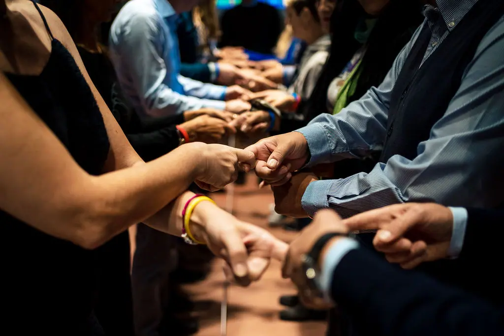 Mani dei partecipanti che si incrociano per una attività